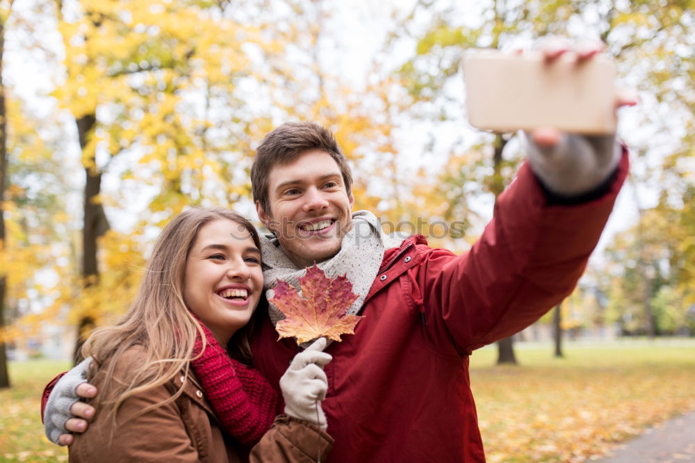 Similar – Young couple taking selfie photo with smartphone outdoors