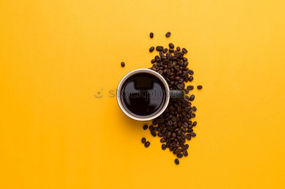 Similar – Top view of black coffee and coffee beans on yellow