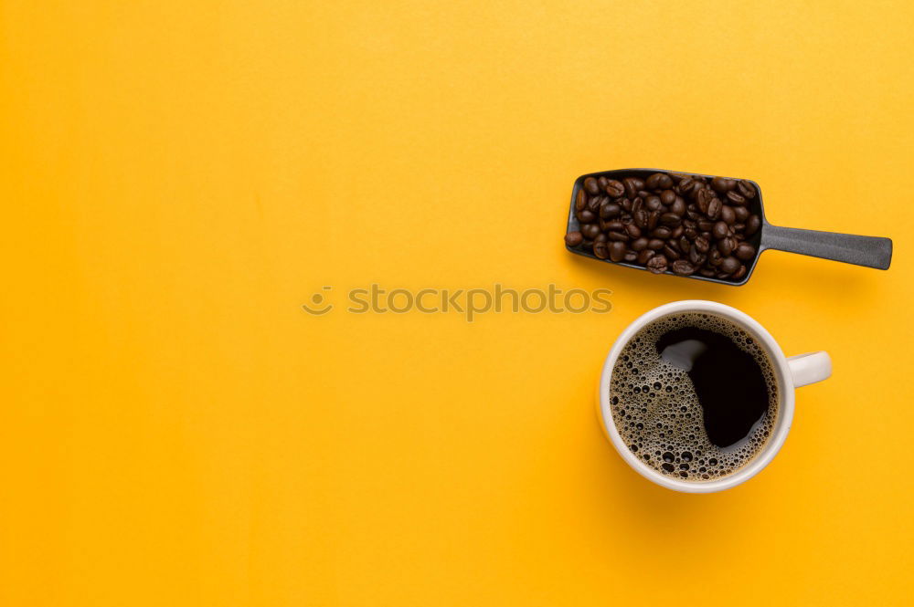 Similar – Top view of black coffee and coffee beans on yellow