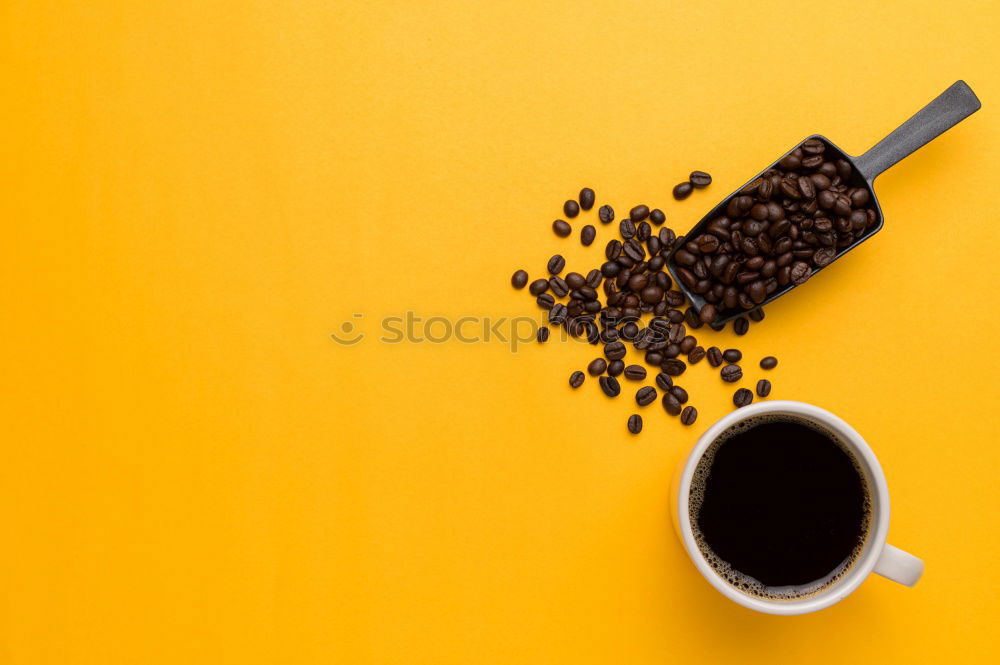 Similar – Top view of black coffee and coffee beans on yellow