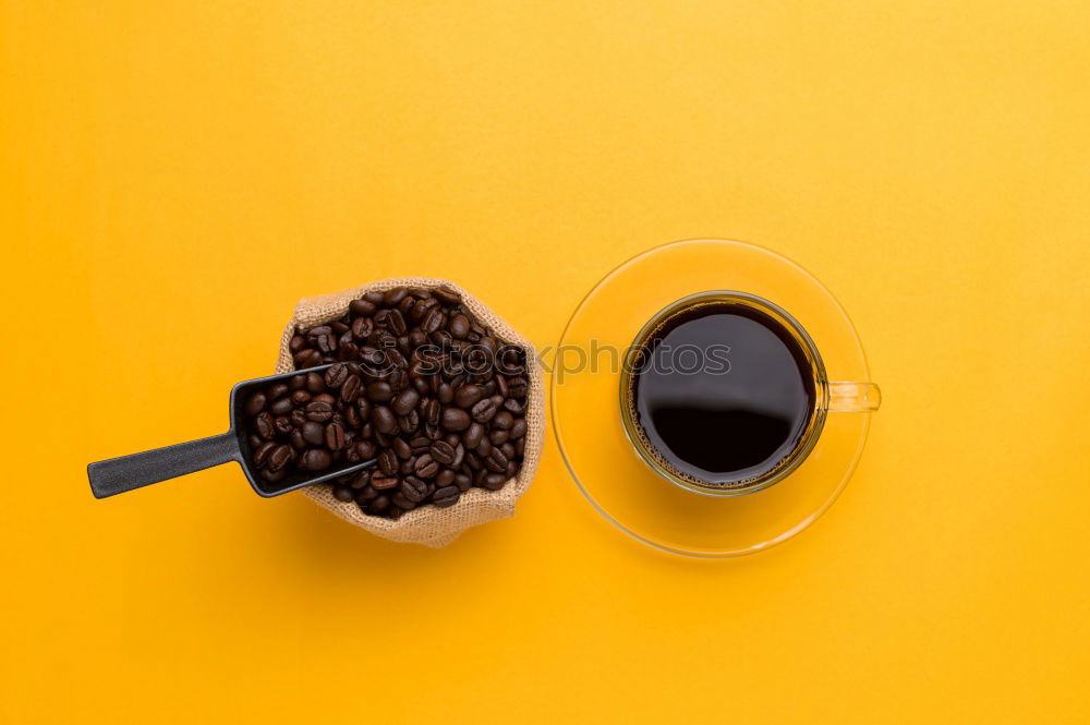 Similar – Top view of black coffee and coffee beans on yellow