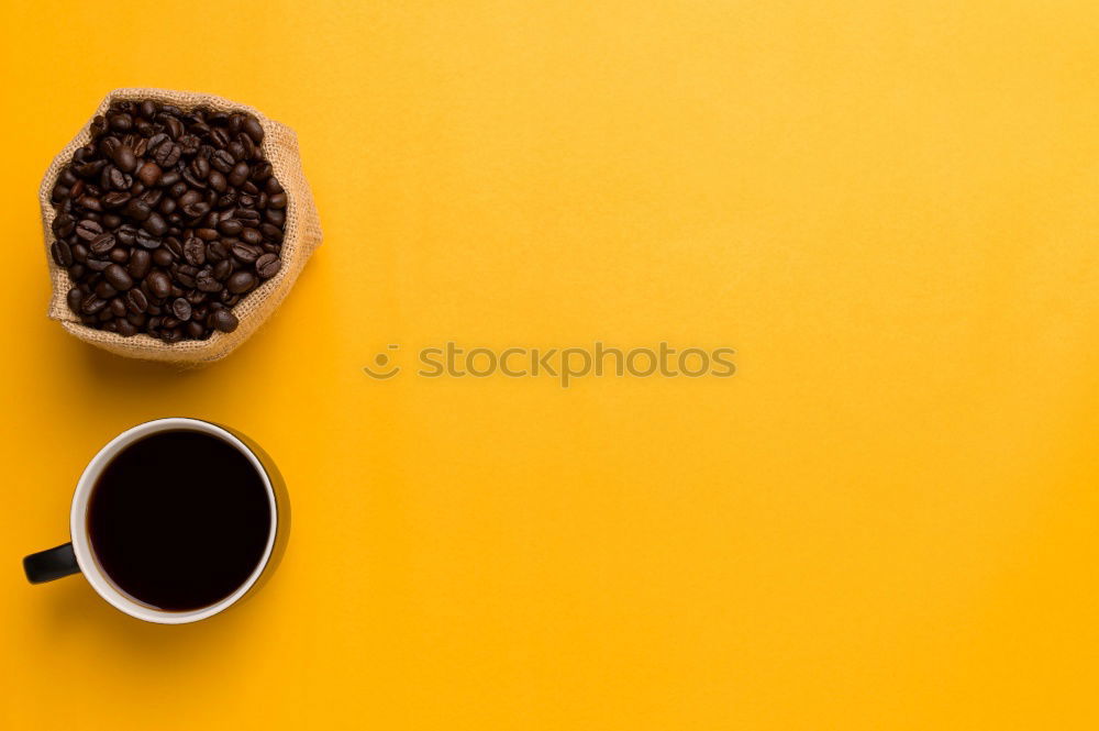 Similar – Top view of black coffee and coffee beans on yellow