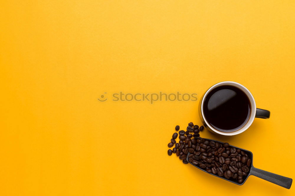 Similar – Top view of black coffee and coffee beans on yellow