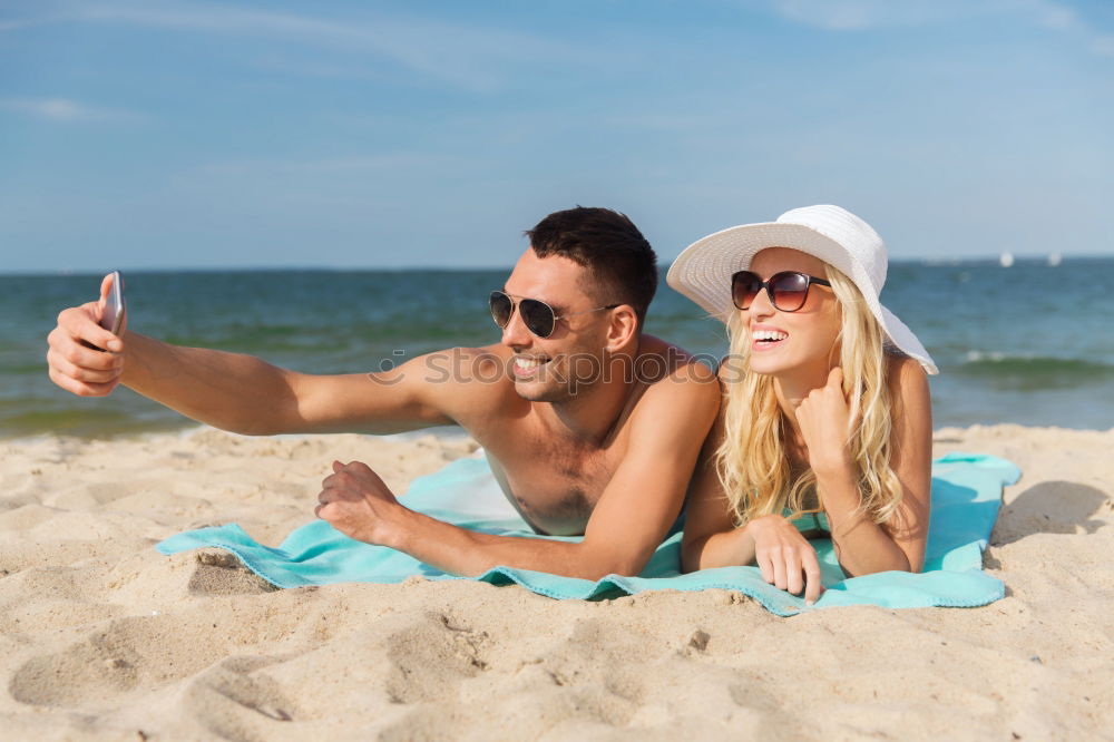 Similar – Happy young man and woman in fashionable sunglasses taking cellphone selfie on background of defocused blue sea. Vacation photos