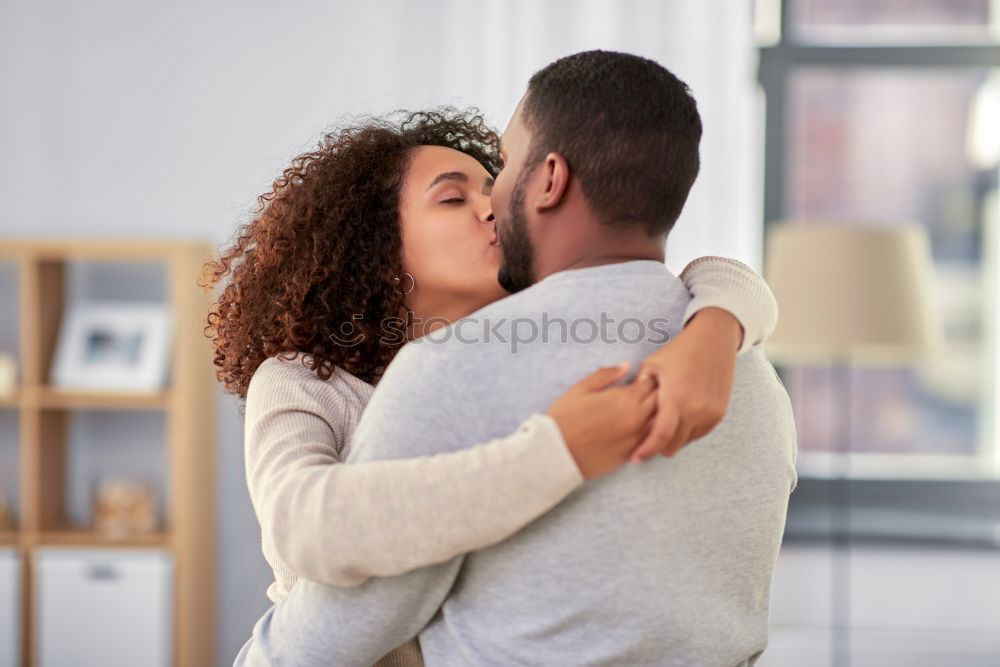 Similar – Loving Young Couple Hugging And Kissing At Home Standing In Kitchen Together