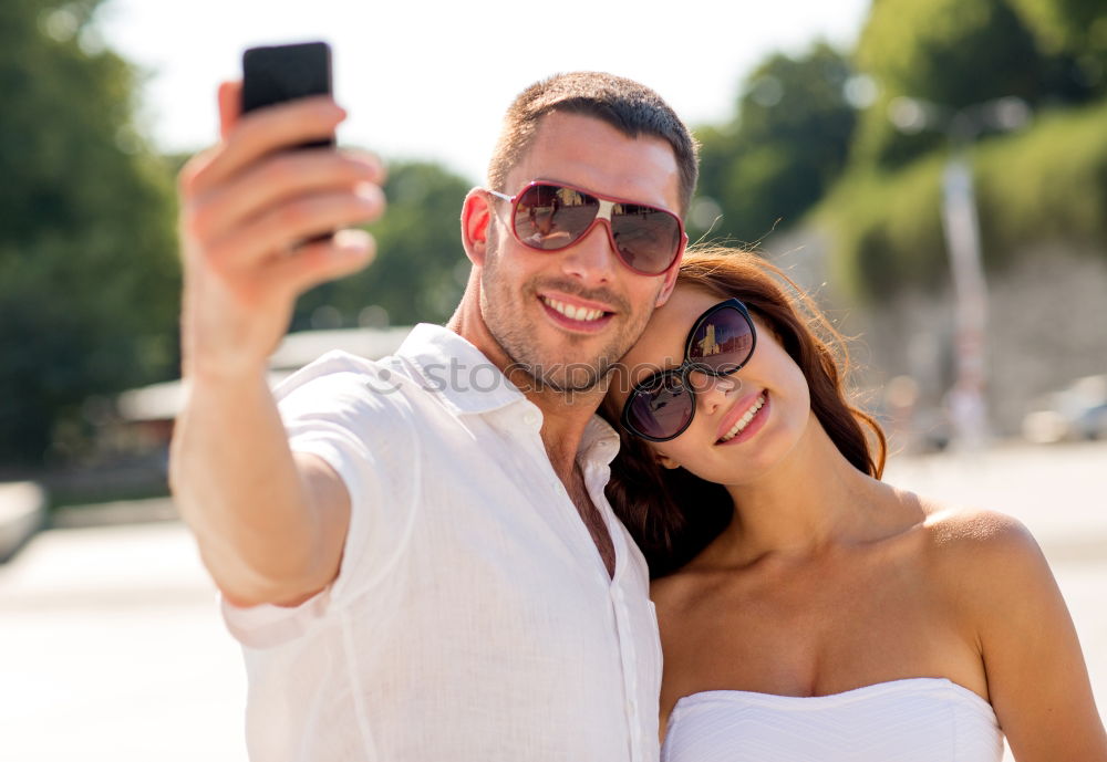 Similar – Image, Stock Photo Romantic Young Couple taking a photo with mobile phone.