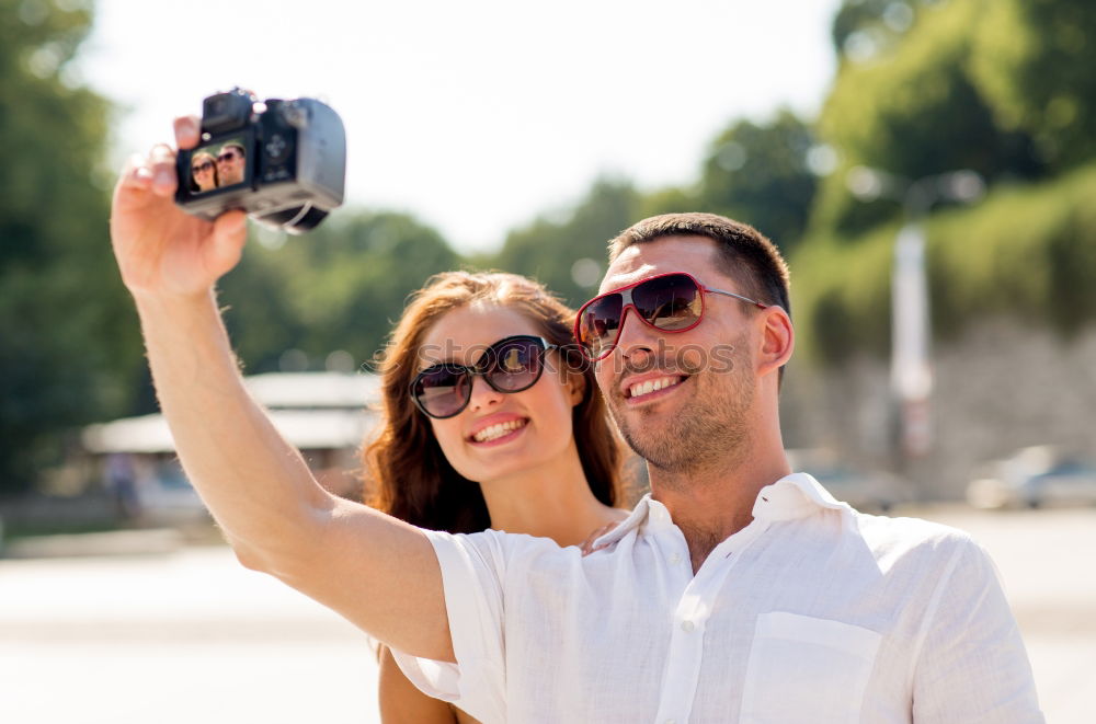 Similar – Image, Stock Photo Romantic Young Couple taking a photo with mobile phone.