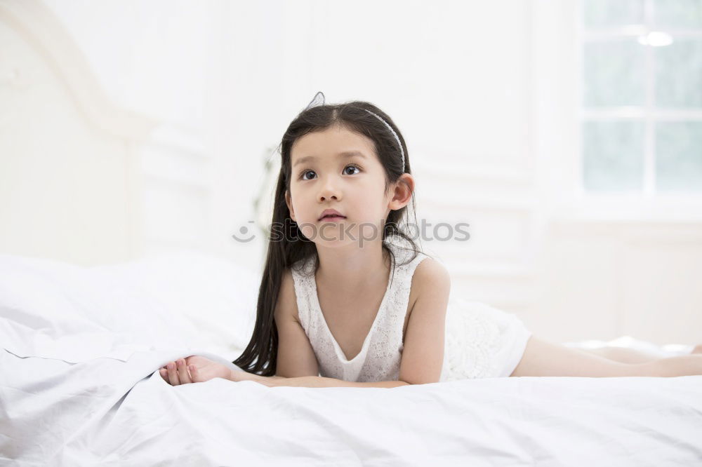 Similar – happy little child girl lying on her bed in the morning