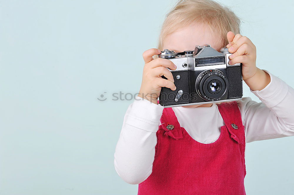 Similar – WOMAN WITH ANALOG CAMERA I