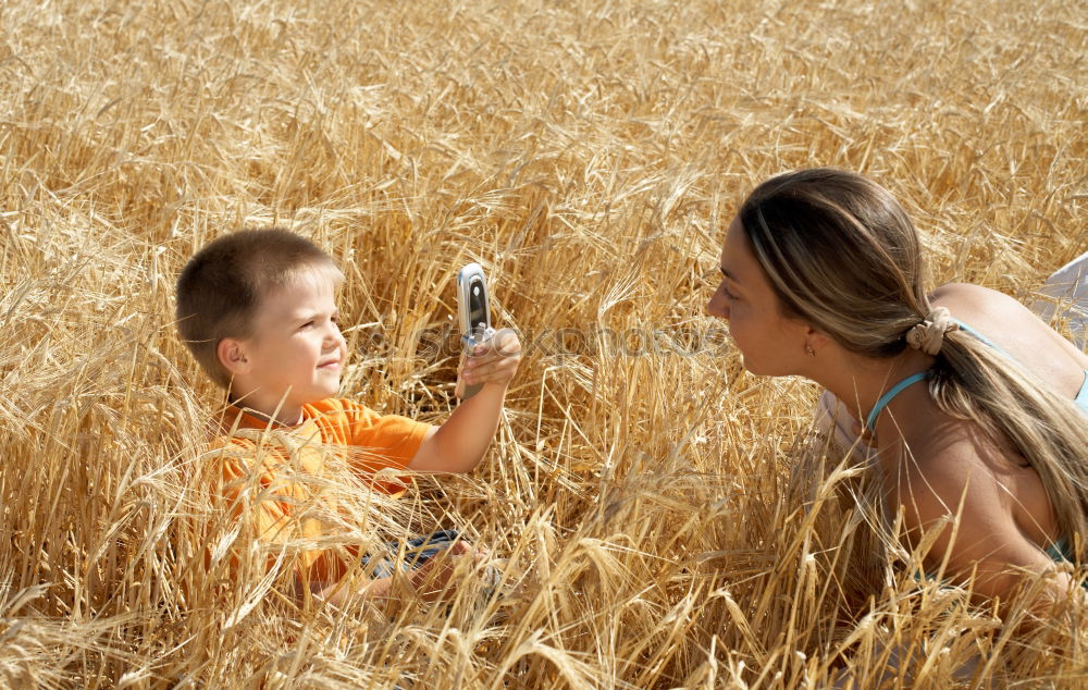 Similar – Brothers playing in the field.Children take pictures in the straw field