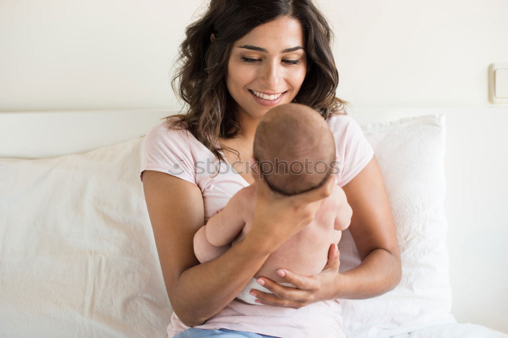 Similar – Image, Stock Photo Young mother holding her baby in the bedroom