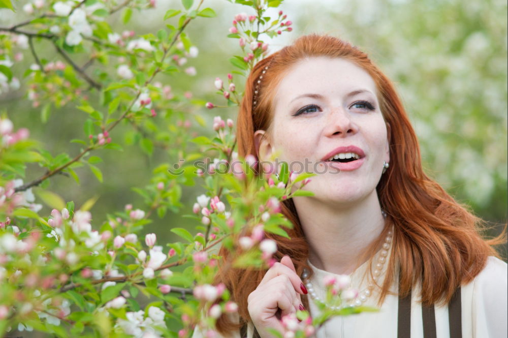 Similar – Pretty woman standing with white flowers