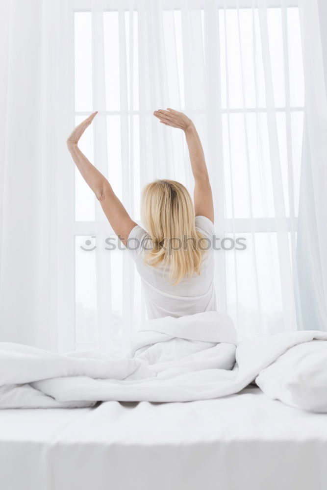 Similar – Woman stretching in bed