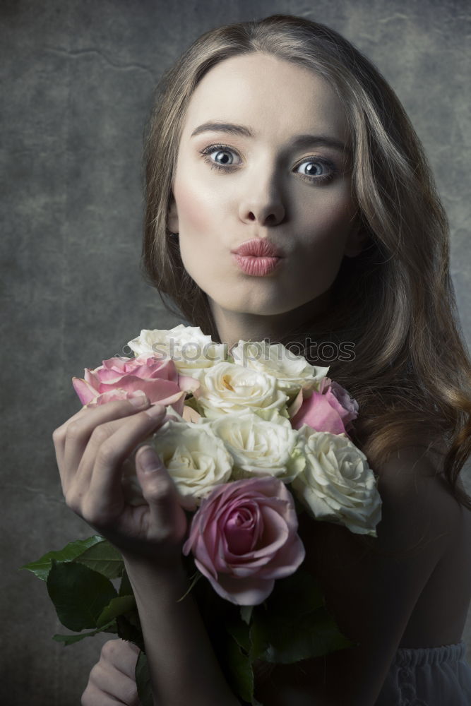 Pretty woman standing with white flowers