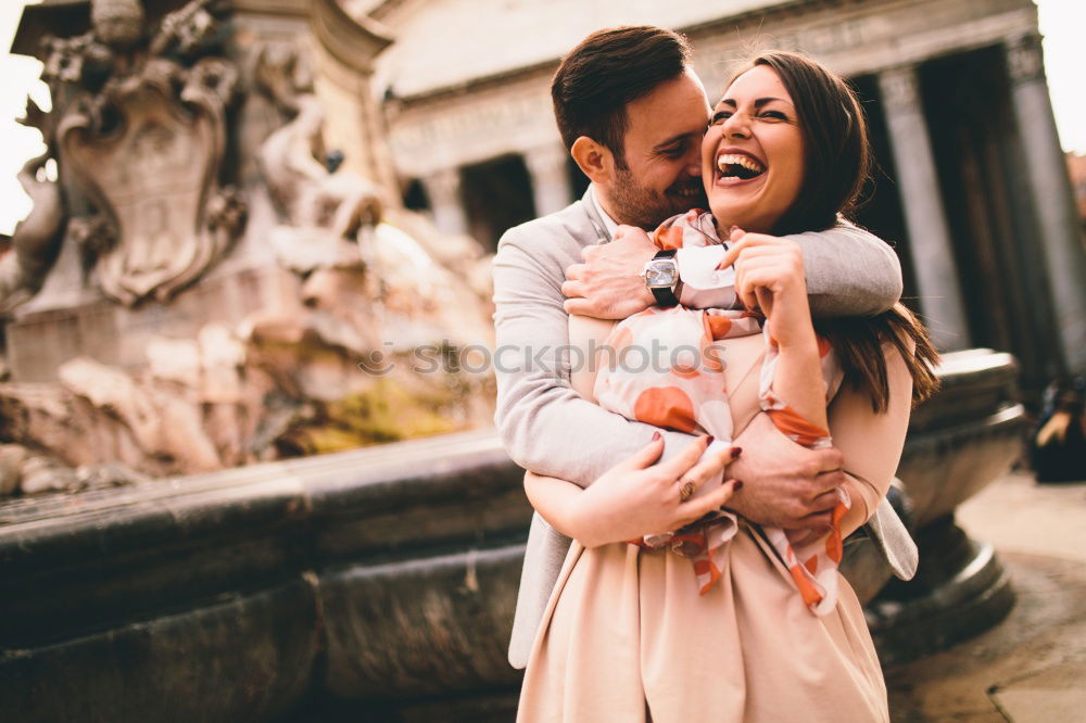 Similar – Couple embracing on evening street