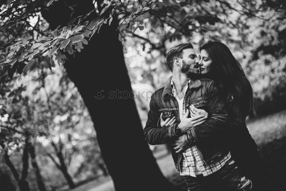 Similar – Image, Stock Photo Happy couple hugging and kissing near tree in park