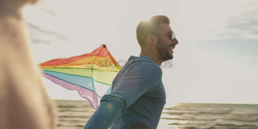 Similar – Image, Stock Photo Young woman holding a rainbow flag behind a fence