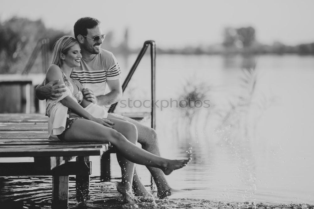 Similar – Couple lying at lake together