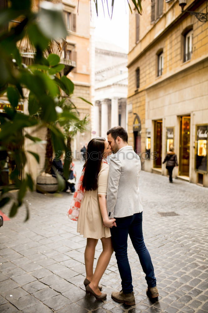 Boyfriend embracing his girlfriend in the street