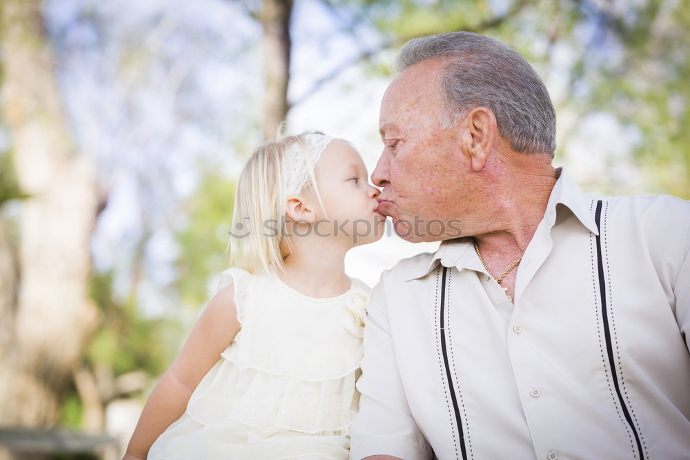 Grandfather With His grandson on the lake. Back view