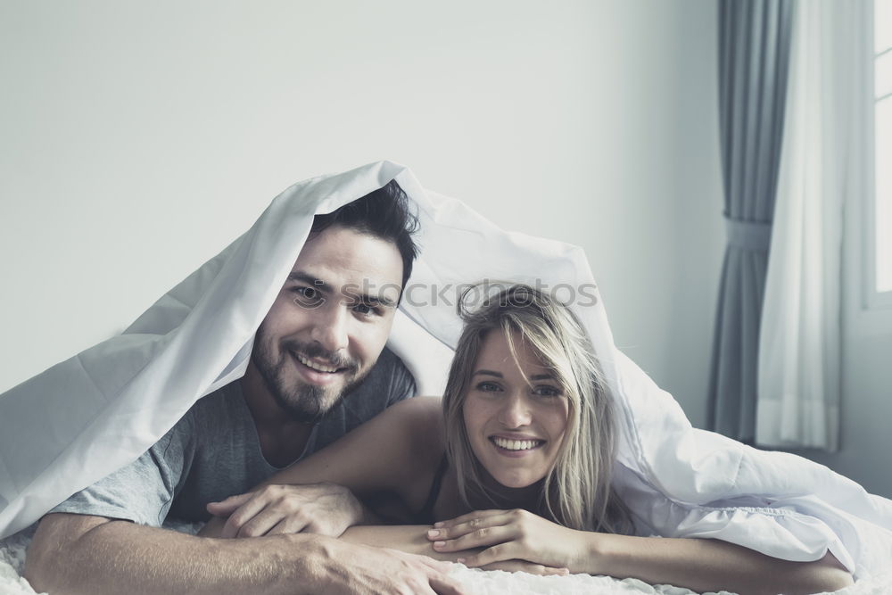 Similar – Happy couple embracing on bed