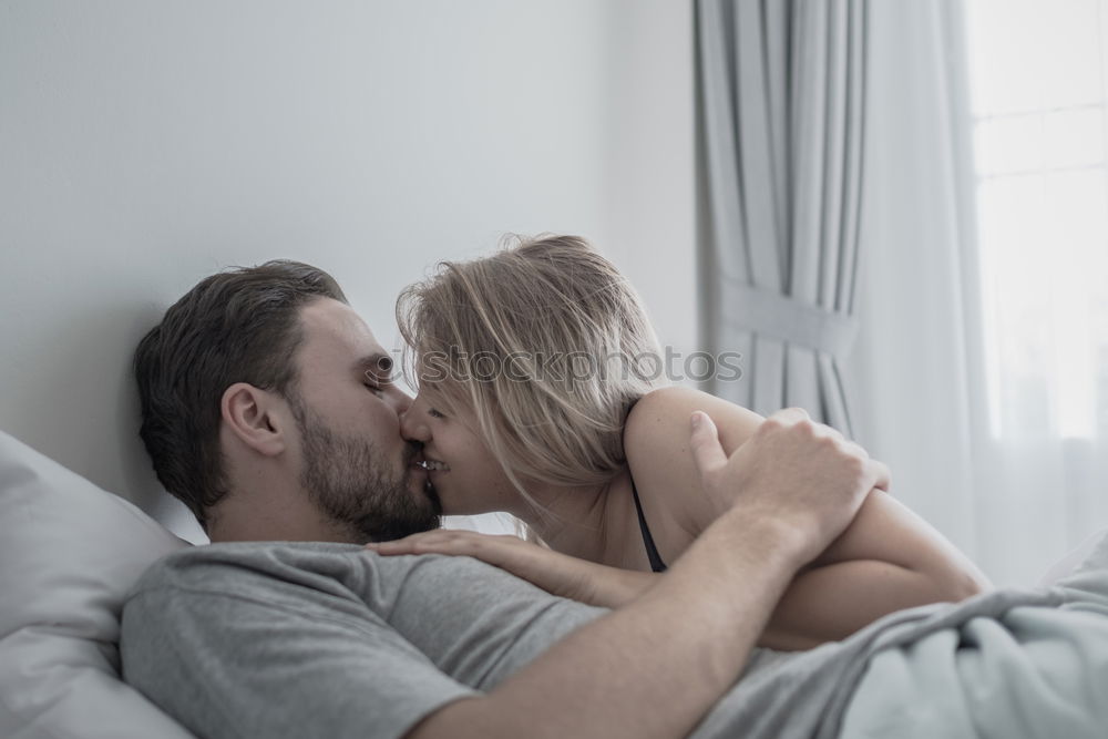 Similar – Boyfriend giving his girlfriend a kiss in the bed