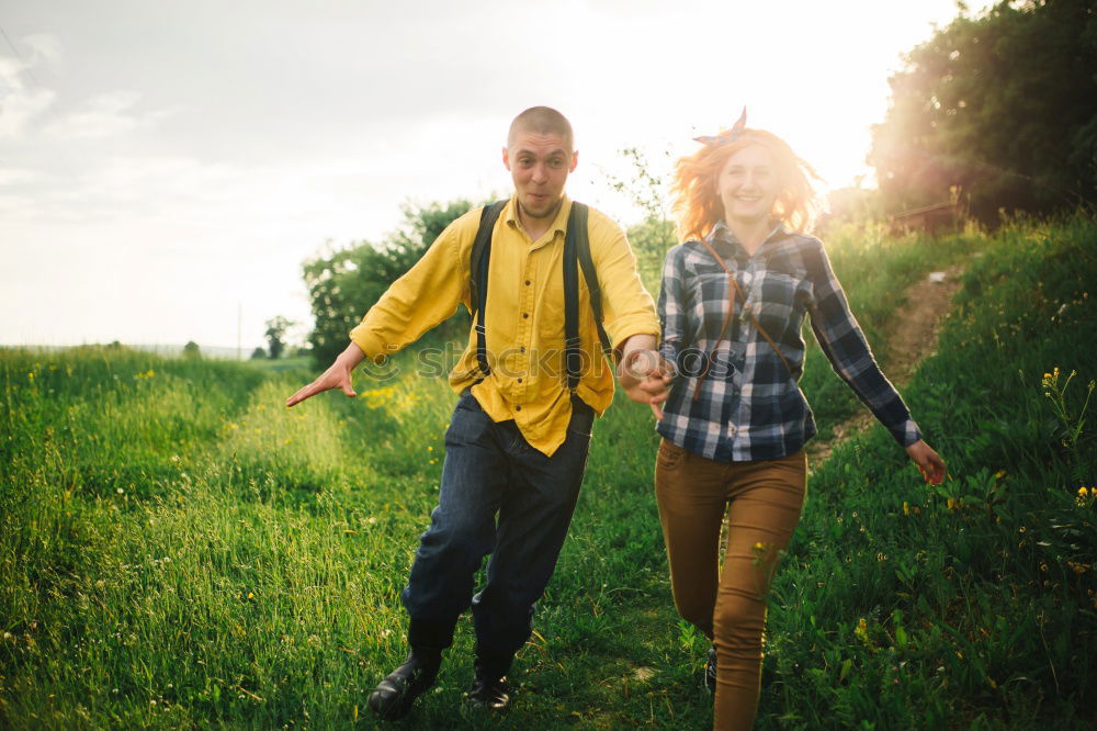 Similar – Image, Stock Photo Young adult adventerous couple hitchhiking together