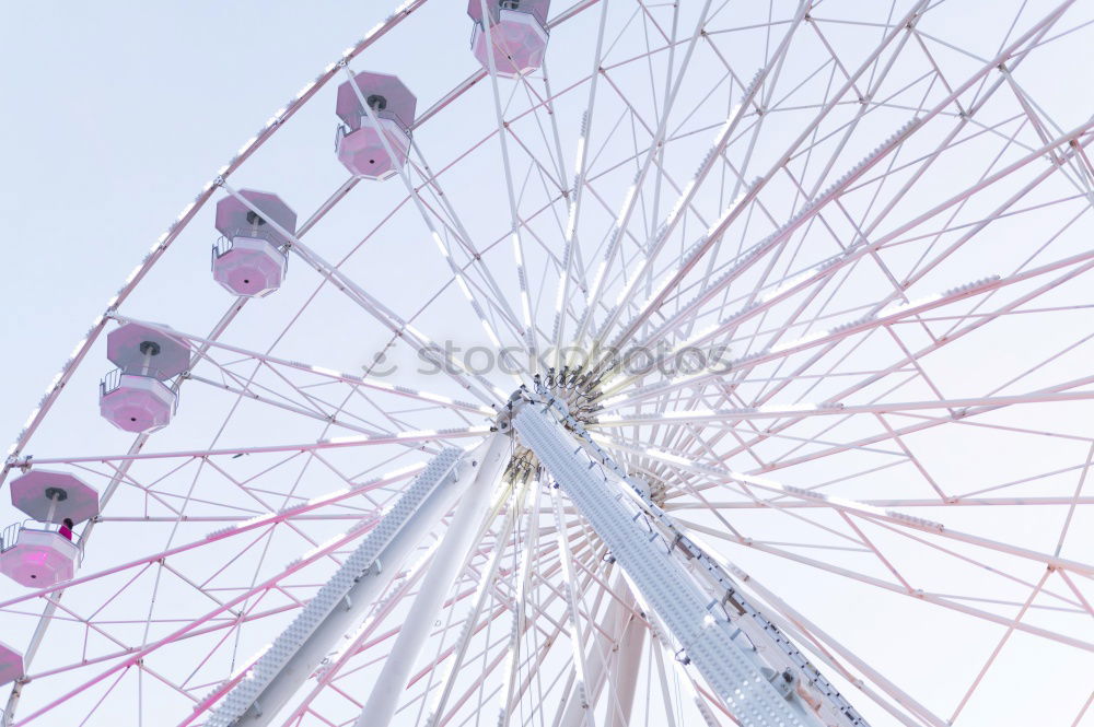 Similar – Bottom view of a ferris wheel against a clear sky