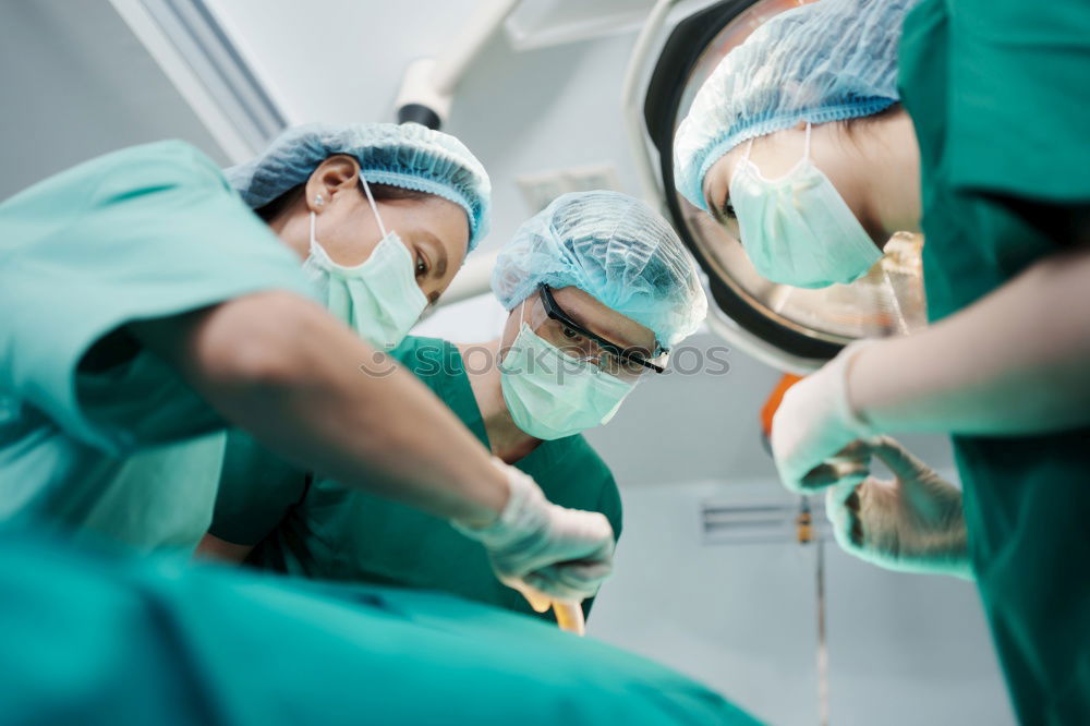 Similar – Image, Stock Photo Team of Surgeons Operating.