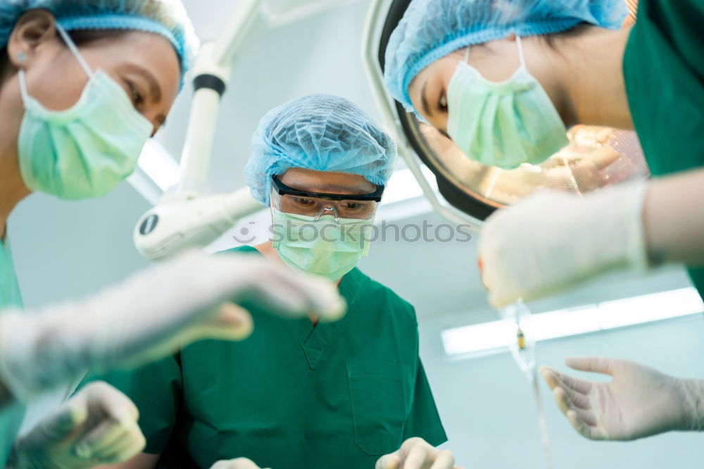 Similar – Image, Stock Photo Team of Surgeons Operating.