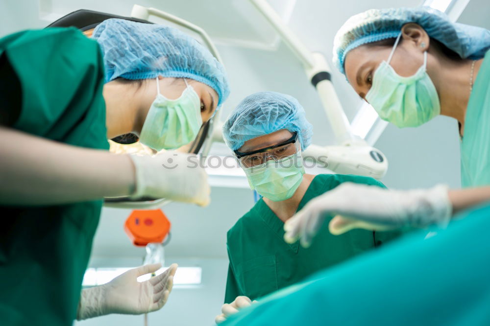 Similar – Image, Stock Photo Team of Surgeons Operating.