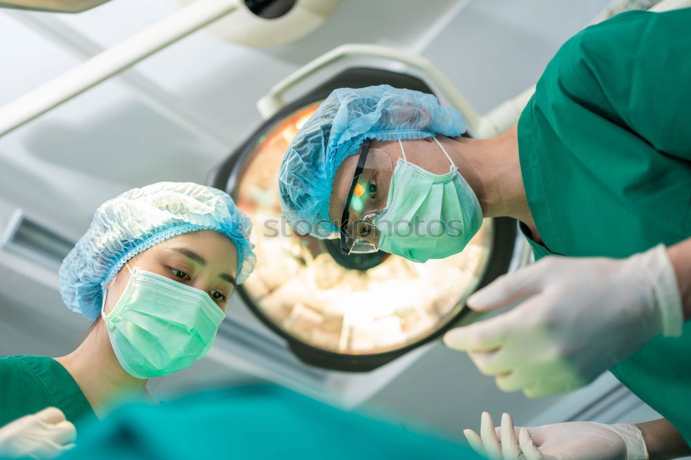 Similar – Image, Stock Photo Team of Surgeons Operating.