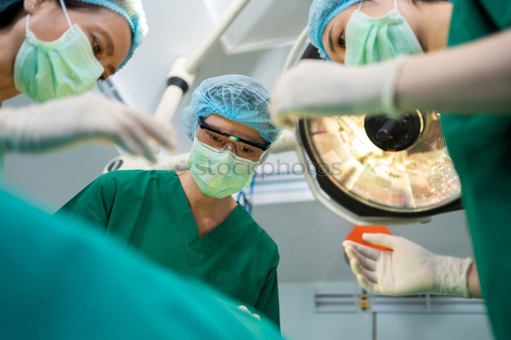 Similar – Image, Stock Photo Team of Surgeons Operating.