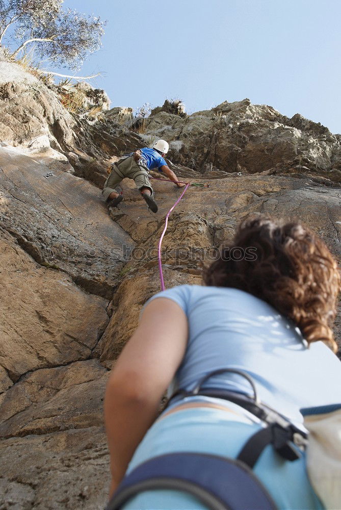 Similar – Image, Stock Photo Young couple rock climbing cliffs at the coast helping eachother