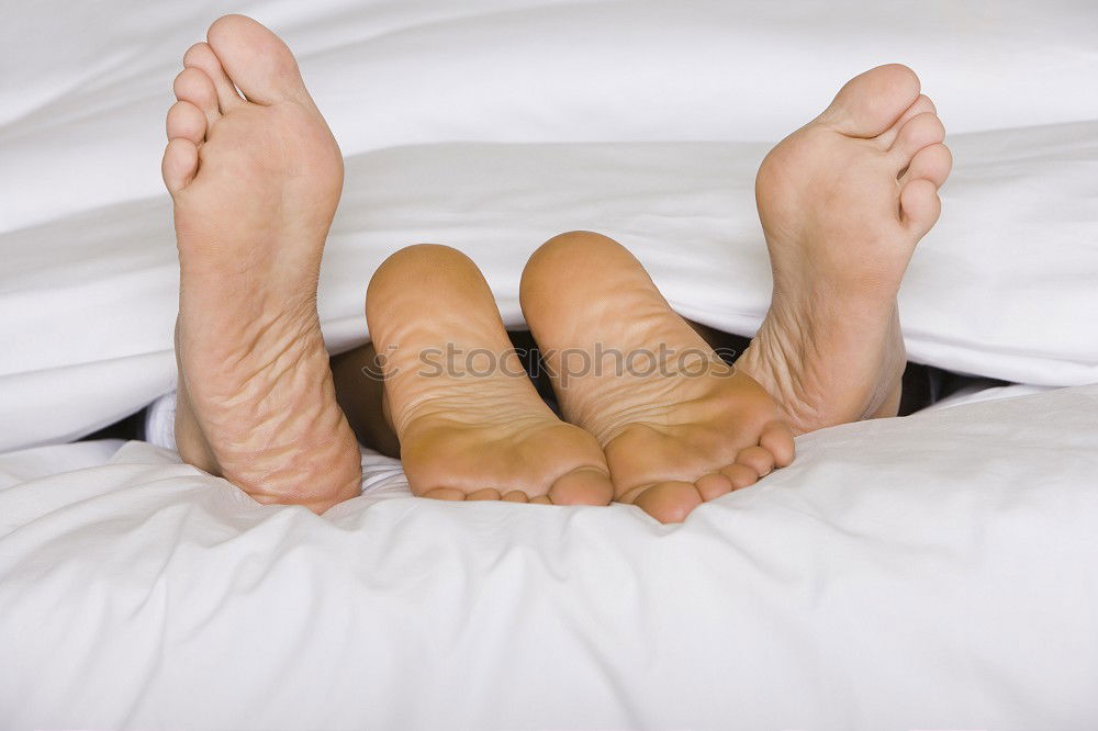 Similar – Image, Stock Photo close up feet of a couple under the white sheets blanket in bed,