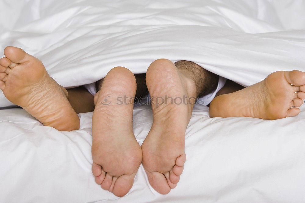 Similar – Image, Stock Photo close up feet of a couple under the white sheets blanket in bed,