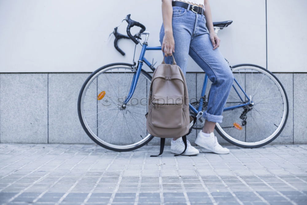 Similar – Stylish urban businessman standing on the street with bicycle