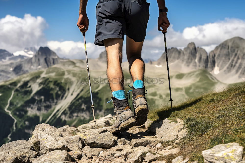 Similar – Woman walking in the mountains with sticks in her hands