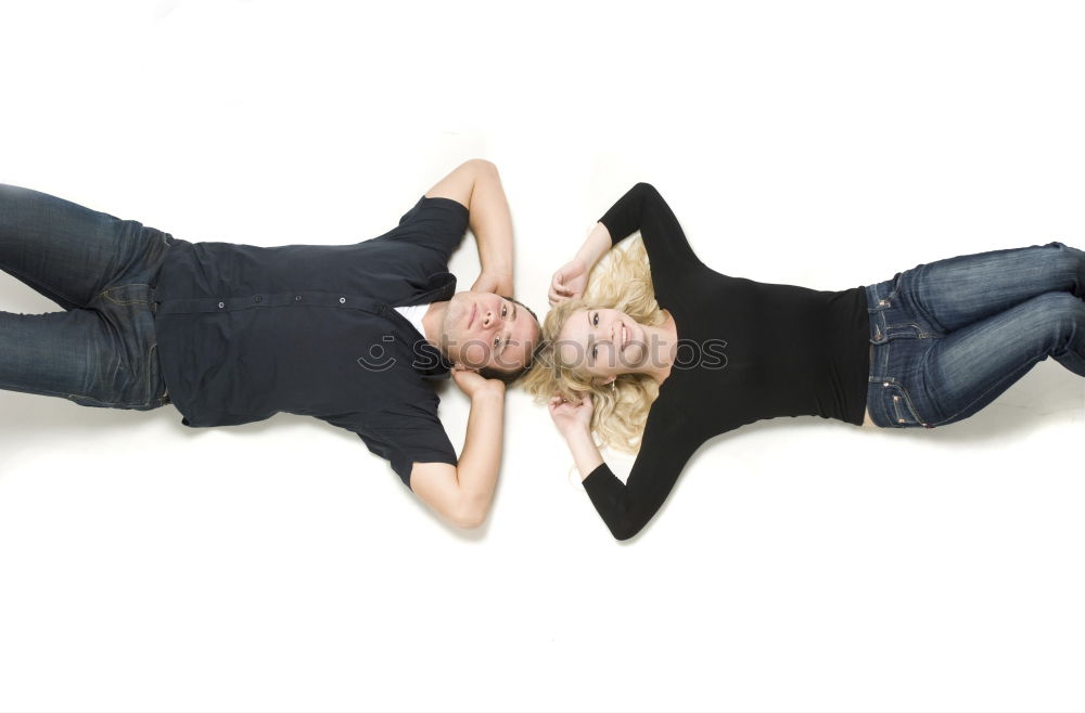 Similar – Two young women lie casually together on a bed with heads and look into the camera