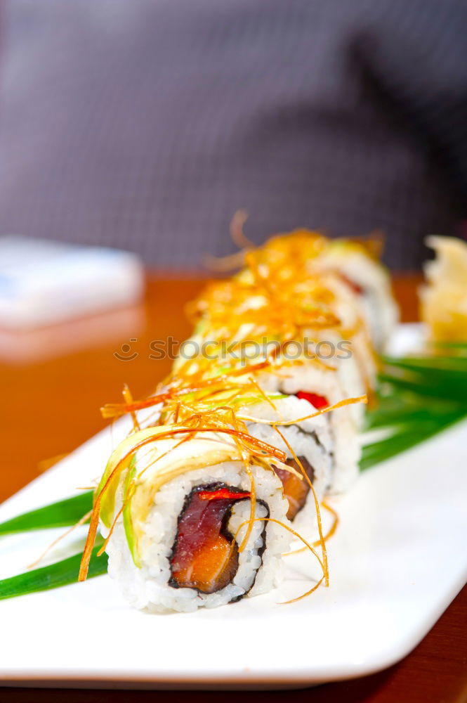 Similar – sushi assortment in white plate on black background