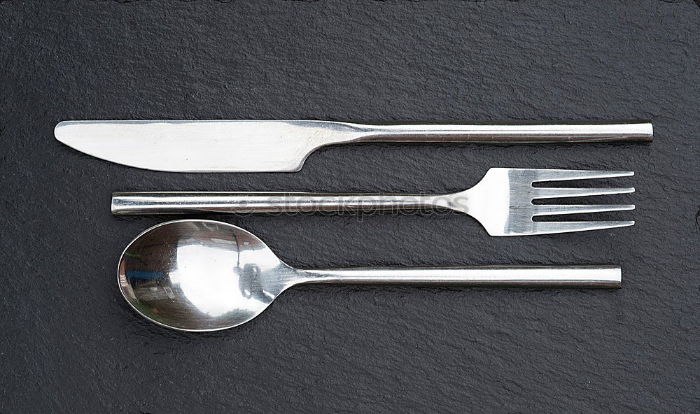 Similar – old metal fork and spoon tied with a brown rope