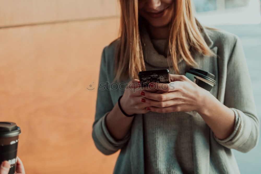 Image, Stock Photo Happy woman using smartphone at a wooden wall