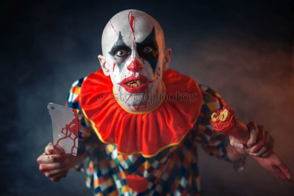 Similar – boy dressed as a clown on black background