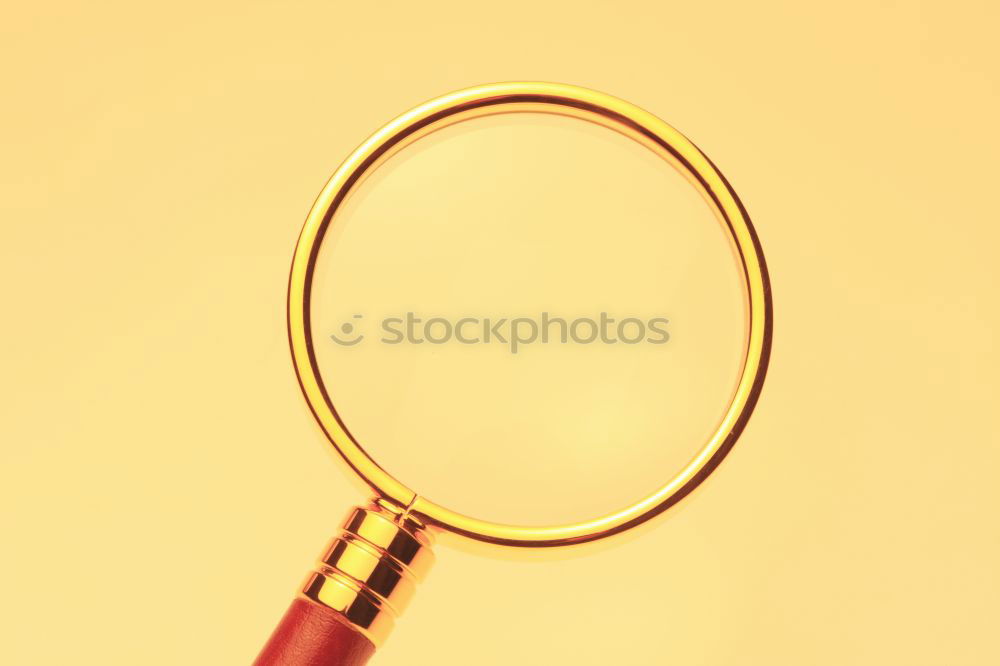 Magnifying glass on yellow background