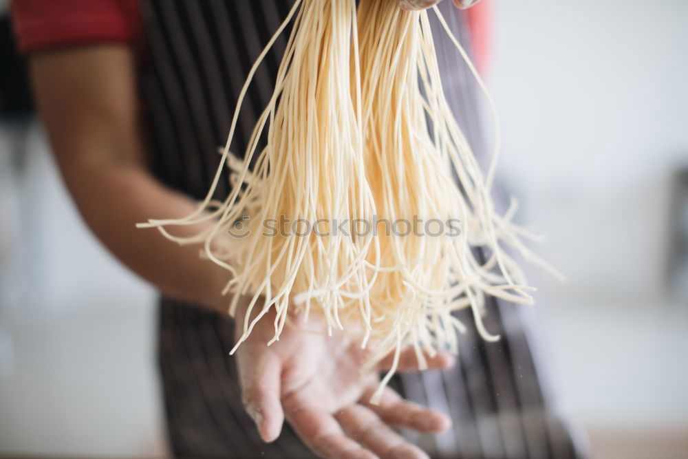 Similar – Image, Stock Photo Making homemade taglatelle with a pasta rolling cutter