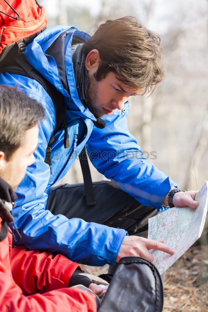 Similar – Image, Stock Photo Couple doing trekking sitting looking mobile and map