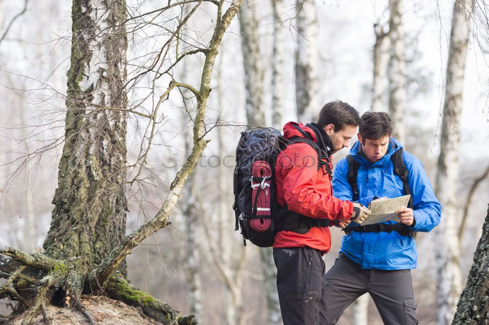 Similar – Image, Stock Photo Couple doing trekking sitting looking mobile and map