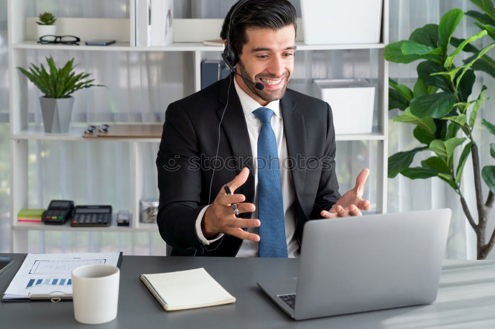 Similar – Image, Stock Photo Businessman enjoying coffee and checking his mobile phone for messages with a smile with his laptop and tablet open on the table