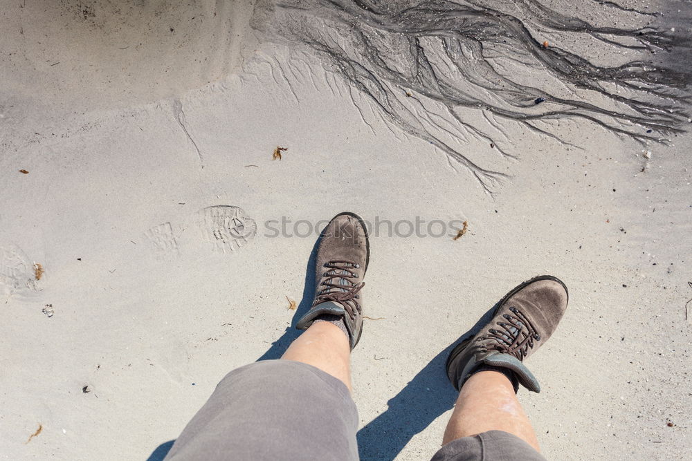 Similar – Image, Stock Photo A woman is standing in the snow.  Next to her two empty footprints. She wears black and white striped stockings and purple boots.