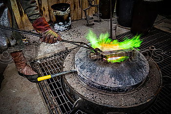 Similar – Blacksmith forges iron on anvil